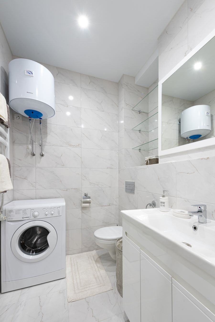 Traditional tank water heater installed in a home bathroom